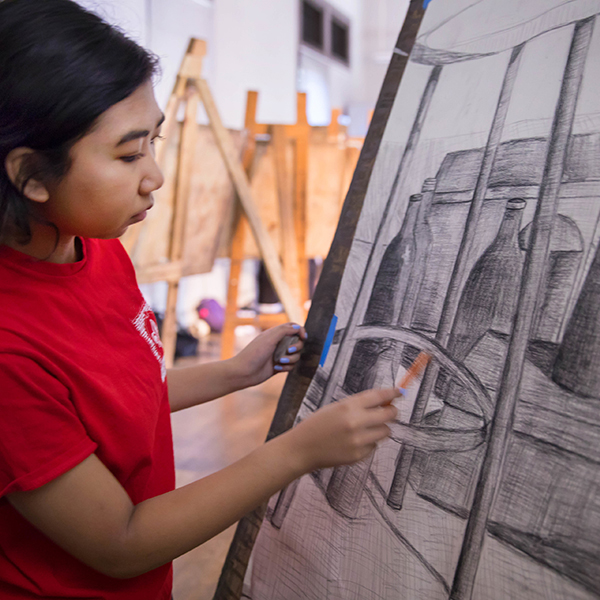 UL student draws on canvas with a pencil